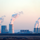 A power plant is pictured with large smoke stacks.